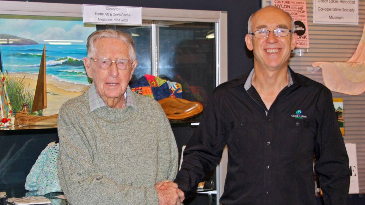Ted Fitzgerald celebrated his 100th birthday by giving $500 to his local library. It was accepted by Great Lakes Library manager Chris Jones.  