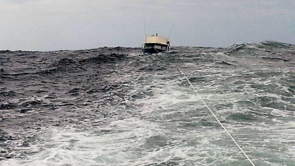 Rescue vessel Cape Hawke tows Cest La Vie through some rough swell.