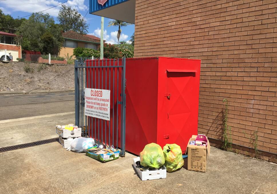 An array of items are dumped out the front of the Salvation Army charity bin 