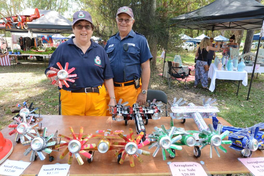 Raising funds: Glenys Campbell and Alan Murphy from the Diamond Beach RFS showed off the aeroplanes at the Black Head bazaar last month.