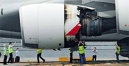 Technicians inspect the damaged engine of the Qantas A380 forced to make an emergency landing in Singapore after an engine exploded soon after take-off.