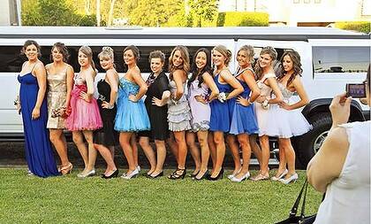 Party planners ... Bridget McCluskey, 19, (black dress with dark hair) and her friends pose for photos in front of one of their two stretch Hummers.