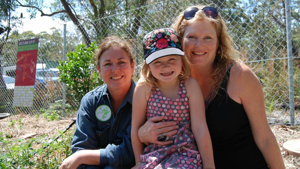 IN THE GARDEN:  Resource Recovery employee and garden facilitator Krysten Banks with Kathy Harrison and her daughter Xannah.