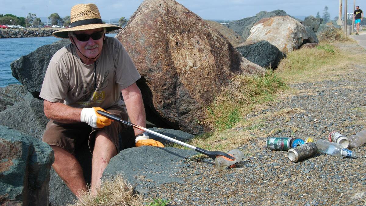 DISSAPOINTING: Wayne Barry from One Mile Beach says it was disappointing to find so many glass bottles lodged in between rocks at Tuncurry. 