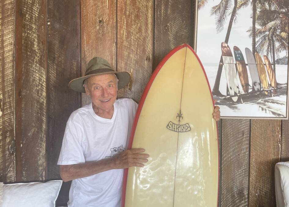 "Shano" holds an original Shane Surfboard in his Crescent Head home. Picture by Ellie Chamberlain