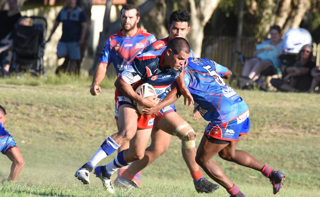 Old Bar centre Clint Walker tries to avoid a Wauchope defender during a Group Three clash at Old Bar last season.