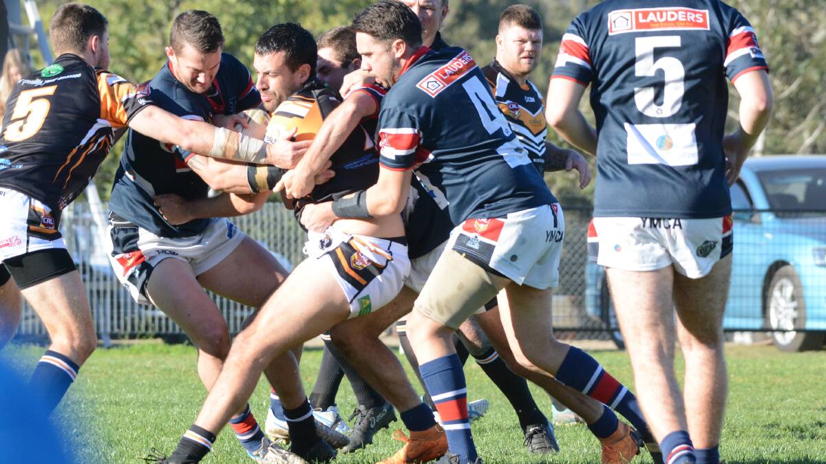 Old Bar defender converge on Wingham's Nathan Maher during the clash at Wingham last Saturday. Wingham won 36-10.