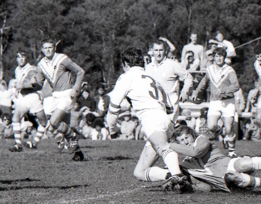 John Adamson is tackled by Taree United's Harold Henry during the 1971 Group Three grand final. Adamson will be inducted into the Group Three Hall of Fame on November 29.