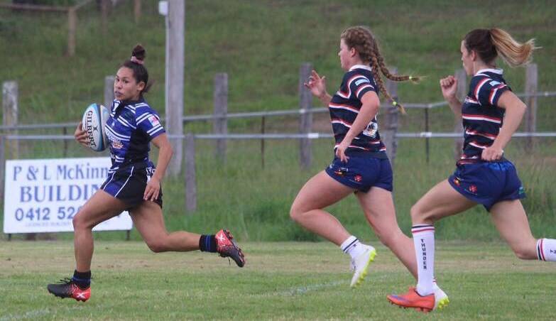 Talented rugby union player Courtney Currie races away from defenders.
