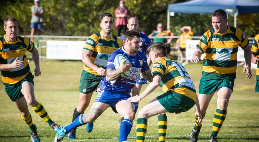 The Wallamba Bulls’ inside-centre James Dinnan attempts to evade the Forster Tuncurry Dolphins’ fullback Jonathon Paff (15) in the Dolphins’ 17-9 major semi-final win at Tuncurry. The Dolphins will play Manning Ratz in the final on Saturday at Nabiac. Photo Zac Lyon,