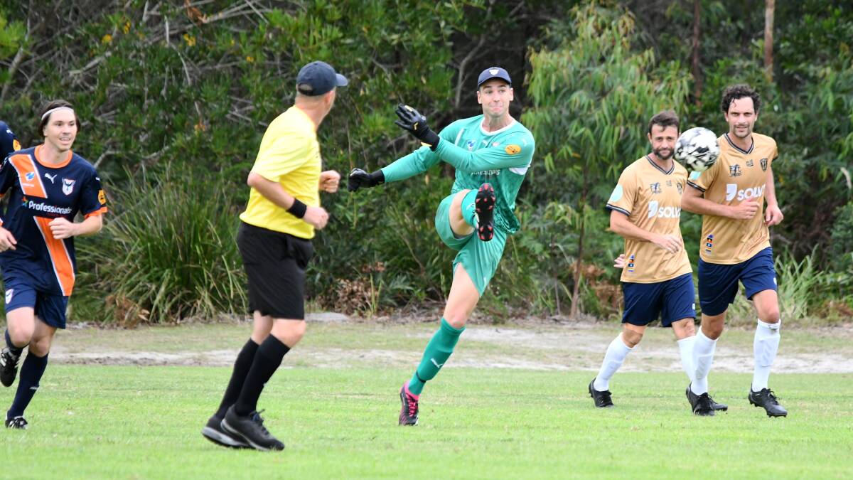 Southern United goal keeper Rhys Daws clears the ball during the opening round clash against New Lambton at Tuncurry.