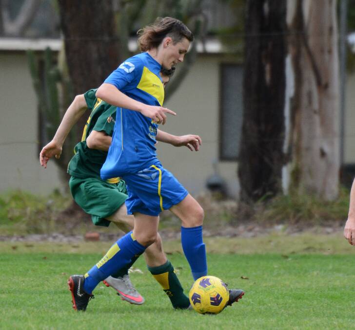 Ryan Williamson goes on the attack for Pacific Palms in the top-of-the-table clash against Wingham played in July. Palms would be a club that could potentially play in a Zone Premier League if it is established.