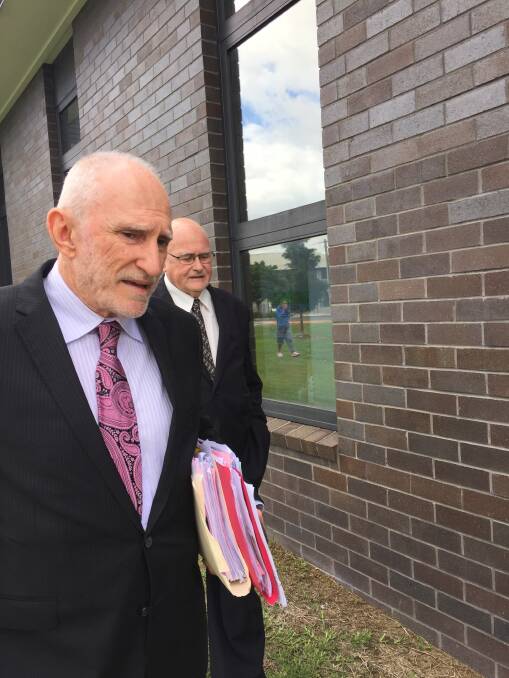 Solicitor Bruce Foate and Father Barry Tunks (behind) after briefly appearing in Forster Local Court on Wednesday, April 5, 2017.