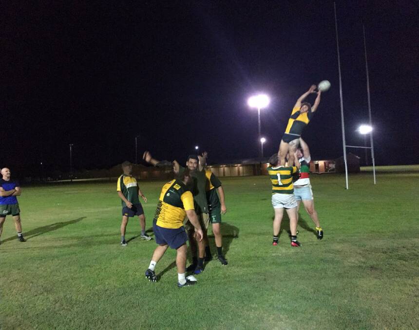 Steve Stanton juggles a lineout throw by Ben Manning at the Forster Tuncurry Dolphins' training session last week. They play premiership winning Manning River Ratz at Peter Barclay Field, Tuncurry, this Saturday.