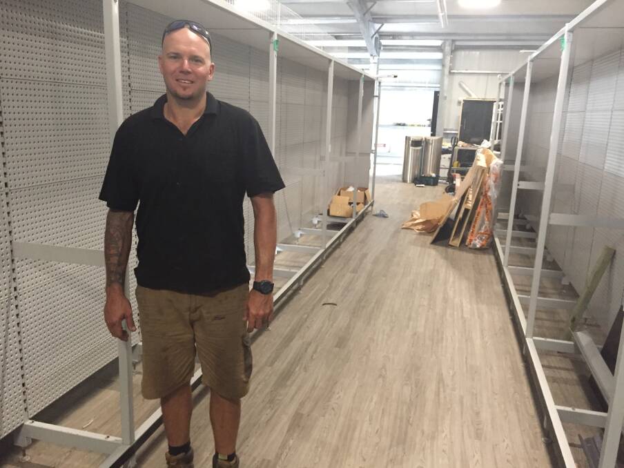 Todd Herring inspectis new shelving for the FoodWorks Supermarket at Charlotte Bay.