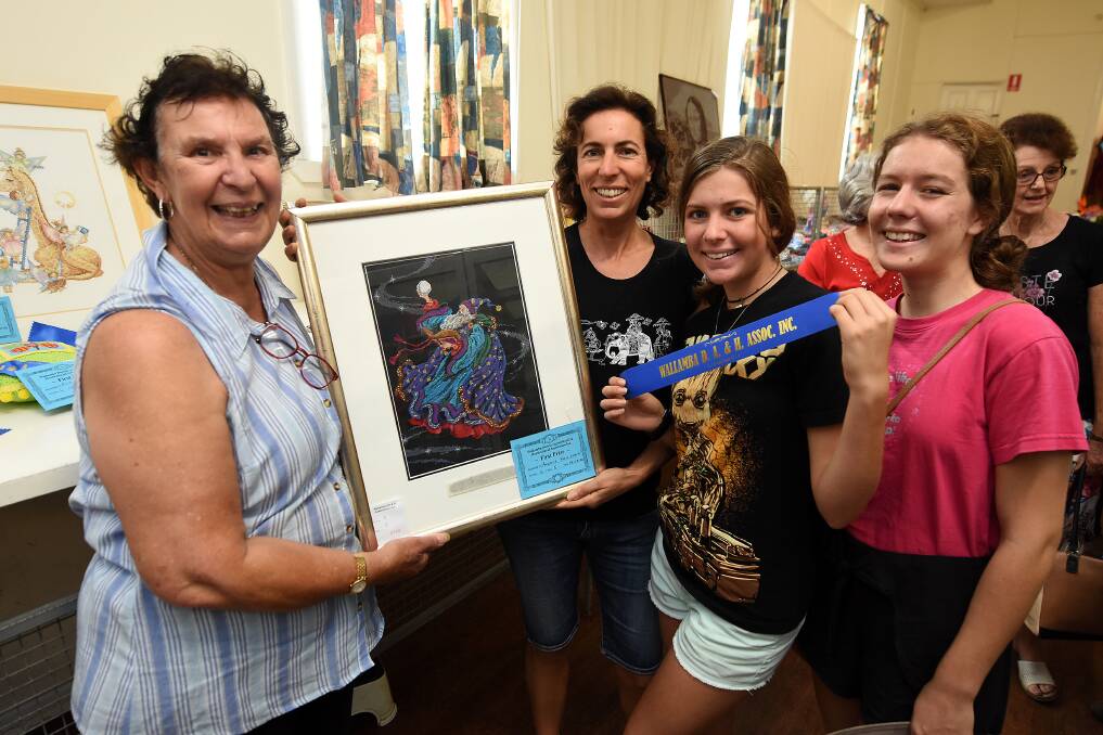 Dorothy Pyett with Angela, Lucy and Amber Kelleher who won counted cross-stitch and framing.
