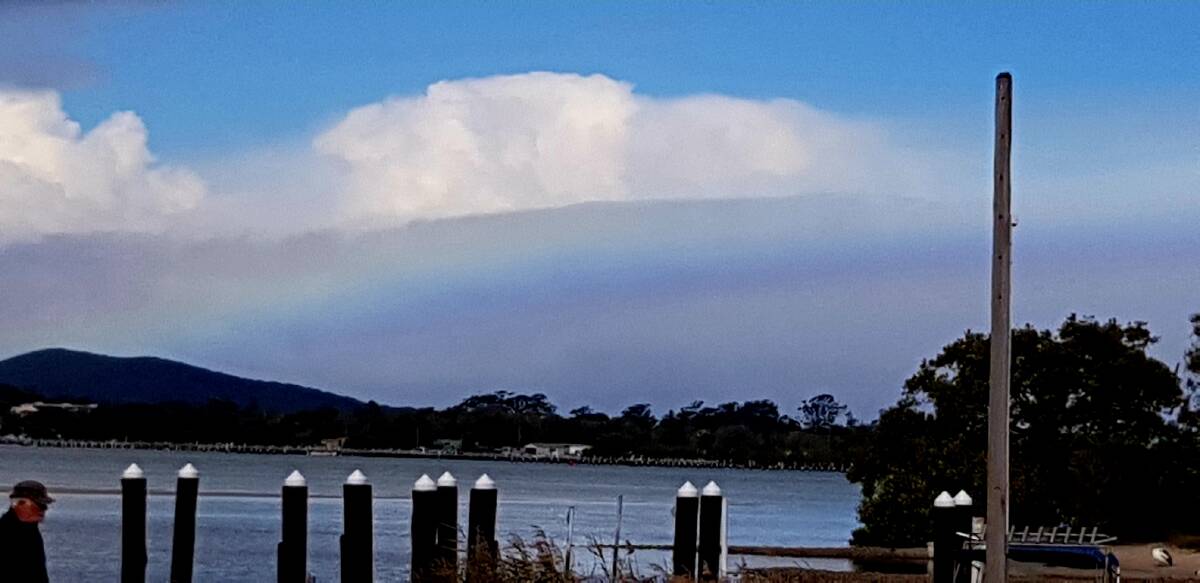 Rainbow cloud spreads across the afternoon sky