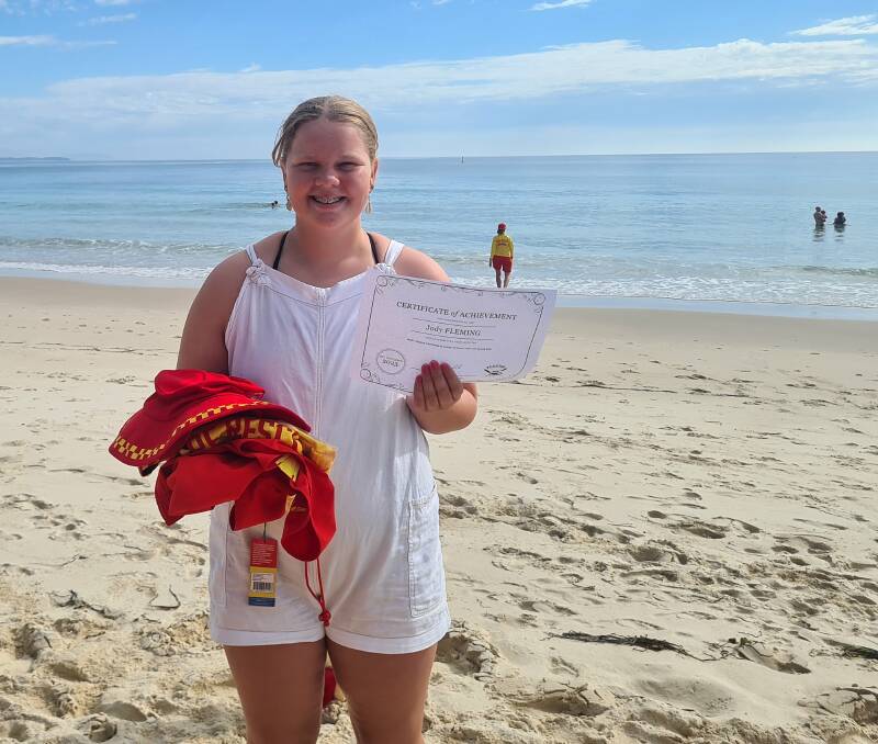One of Forster Surf Life Saving Club's newest volunteers, Jody Fleming, proudly shows off her Surf Rescue Certificate. Picture Anne Evans