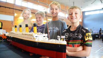 Brickfest will be held in Gloucester in early March. Pictured admiring a model of the Titanic, made from 9090 Lego bricks at the 2022 Tuncurry Brickfest are Lakyn Weatherstone, Harrison Forrest, with Adam and Nathan Pursch. Picture Scott Calvin.