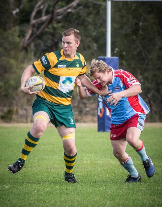 The Forster Tuncurry Dolphins’ lock Lachlan Daczko palms off impressive Old Bar five-eighth Brendon Roberts, when the teams last met in early June.
