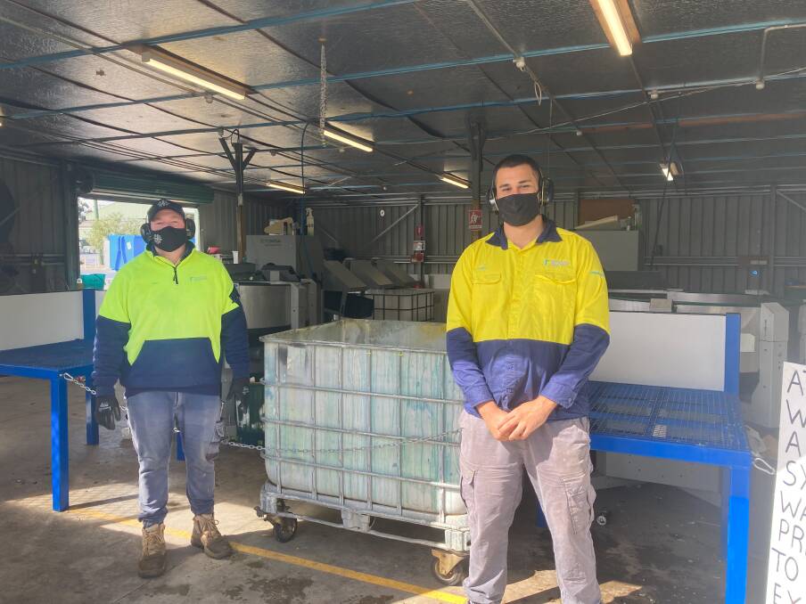 Joel Gordon and Liam Simon at the Tuncurry automated depot, which recently introduced a second singulator.