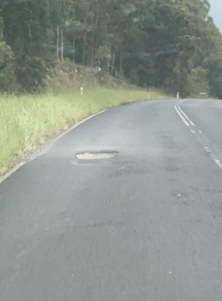 Jill Mcsweeney hit this pothole on The Lakes Way south of Bungwahl and had to buy a replacement tyre. 