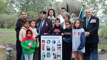 Warrant Officer Class One Colin (Col) Watego, Elvina Oxley, Will Paulson and Worimi youngsters pay their respects to past Aboriginal servicemen. Picture supplied.