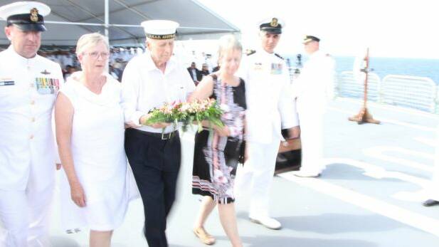 Flanked by his two daughters, Pamela Lange and Marcia James, Bill threw a wreath into the water.