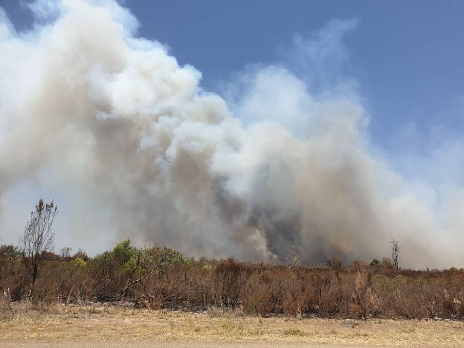 A bushfire burning in Aerodrome Road, Nabiac was taken by Janet Hooper.