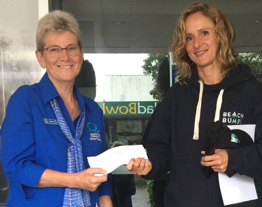 Great Lakes Palliative Care Support president, Deidre Stokes is presented with a $1000 cheque from Creative Christmas Tree winner, Kate Cornell from Beach Bums, Forster.