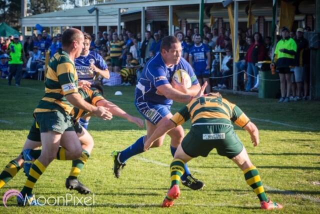 Wallamba’s dual premiership-winning forward Chris Pheiffer  (right) charges at Forster Tuncurry winger, Jesse Logan, with Tom Harris (left) closing in to tackle the prop.

 