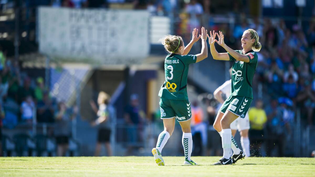 Grace Gill and Georgia Yeoman-Dale celebrate a goal for Canberra United in 2014.
Picture: Rohan Thomson