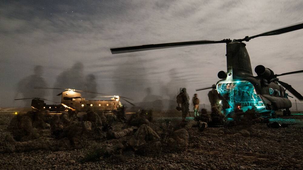 Australian Army soldiers from Special Operations Task Group prepare to board CH-47 Chinook helicopters during a night-time operation in Uruzgan province, Afghanistan, in June 2008. Picture: Department of Defence