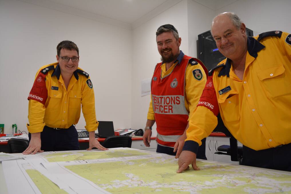 Operations cell: Daniel Gordon, Brett McMillen and David Hagarty take care of the "here and now" of the fire situation. Photo: Anne Keen