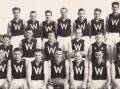 LEADER: The late Neil Kerley is pictured holding the football as captain-coach of the Whyalla combined football team in 1955. 