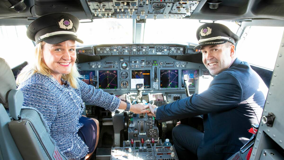 THREE-YEAR DEAL: Newcastle lord mayor Nuatali Nelmes and Port Stephens mayor Ryan Palmer in the cockpit of a Virgin passenger plane at the airport on Tuesday. The two councils are joint owners of the commercial airport.