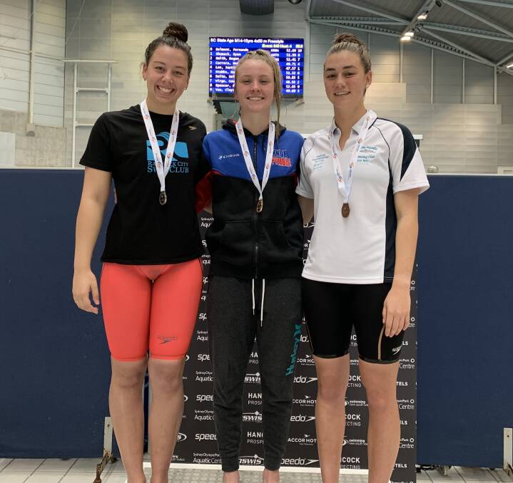 Claire Van Kampen (right) on the podium at the NSW Short Course Championships.