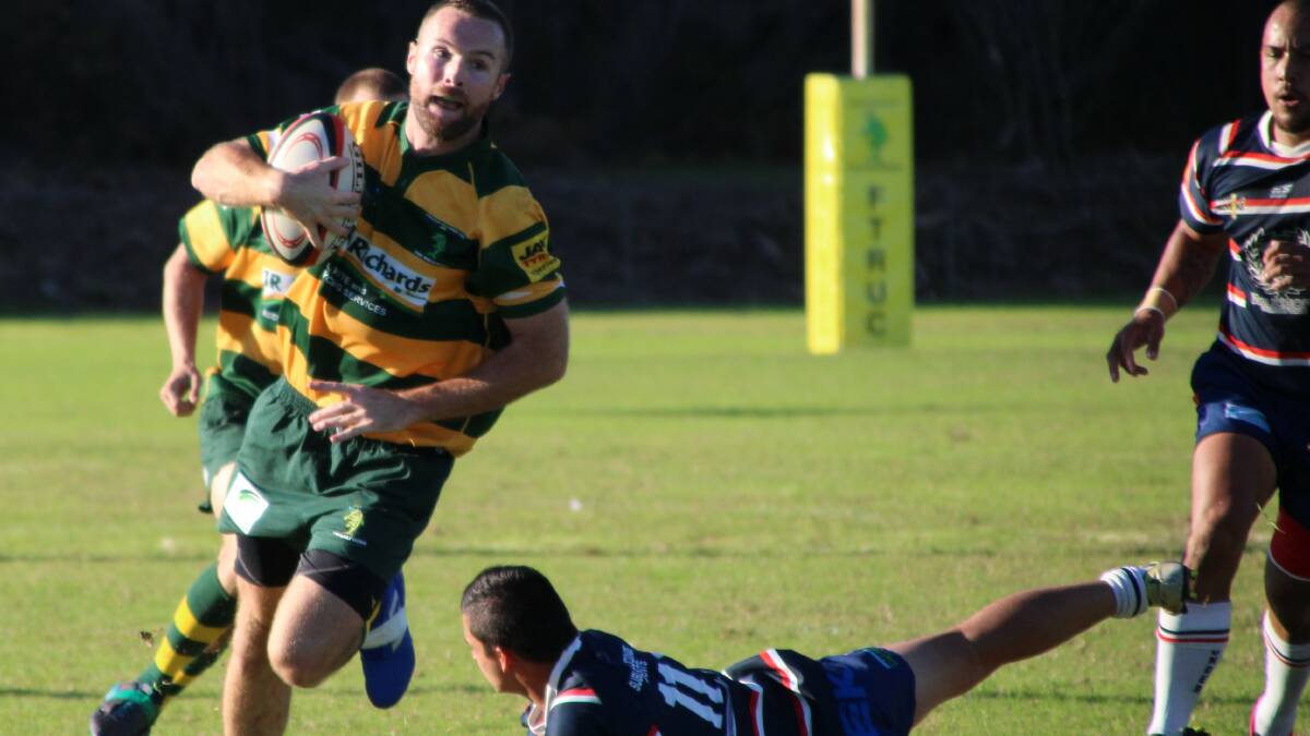 Outside-centre Mark Quillan eludes a Wauchope tackler in the Dolphins' 48-0 defeat of the Wauchope Thunder on Saturday. (Photo: Sue Hobbs)