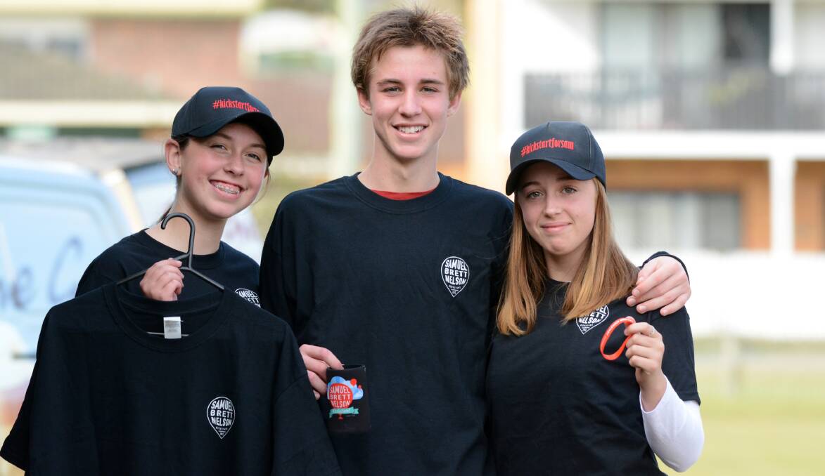 Maddie Summers and Lachlan and Sophie Phillip show off some of the day's merchandise.