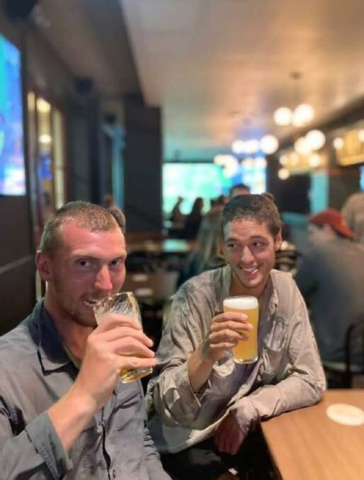 Blake and Nathan enjoy a refreshing drink after a long day of walking. Photo supplied.