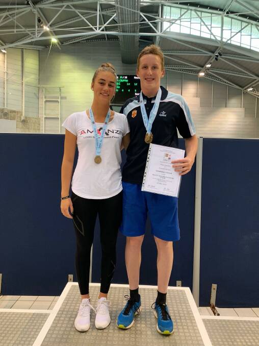 Claire Van Kampen and Nash Wilkes with their medals from the NSW All Schools Secondary Swimming Championships.