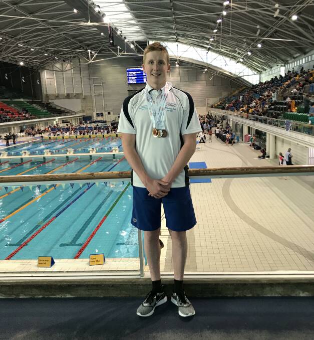 Nash Wilkes with his haul of medals from the NSW Country Swimming Championships.