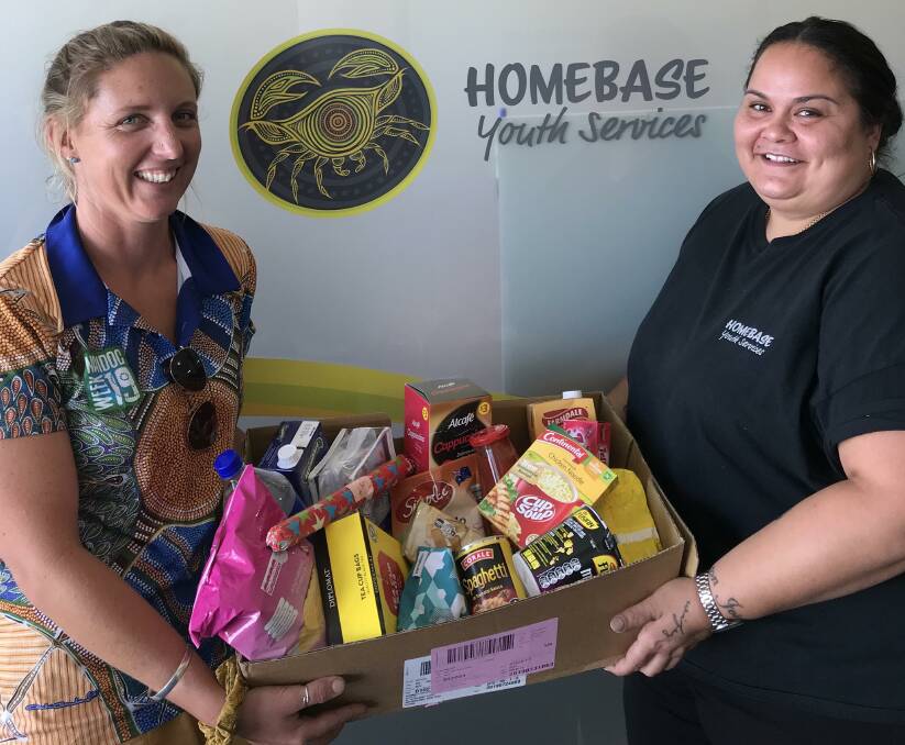 Homebase supported playgroup coordinator Sarah Little and P.A.C.E coordinator Liahna French show off some of the items that will go into the Christmas hampers. Photo supplied.