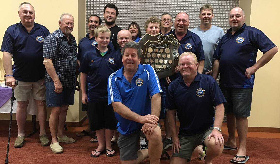 Members of the Newcastle Blue Water Fishing Club hold aloft the prized Rowley Kay shield.