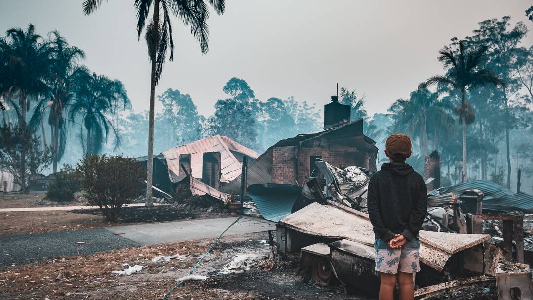 A child surveys a home destroyed by the Hillville fire in Rainbow Flat. Photo: Martin Von Stoll.