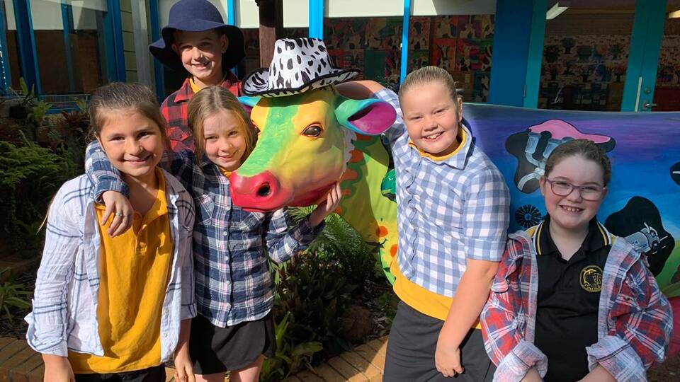Students from Tuncurry Public School with their beautiful bovine creation.