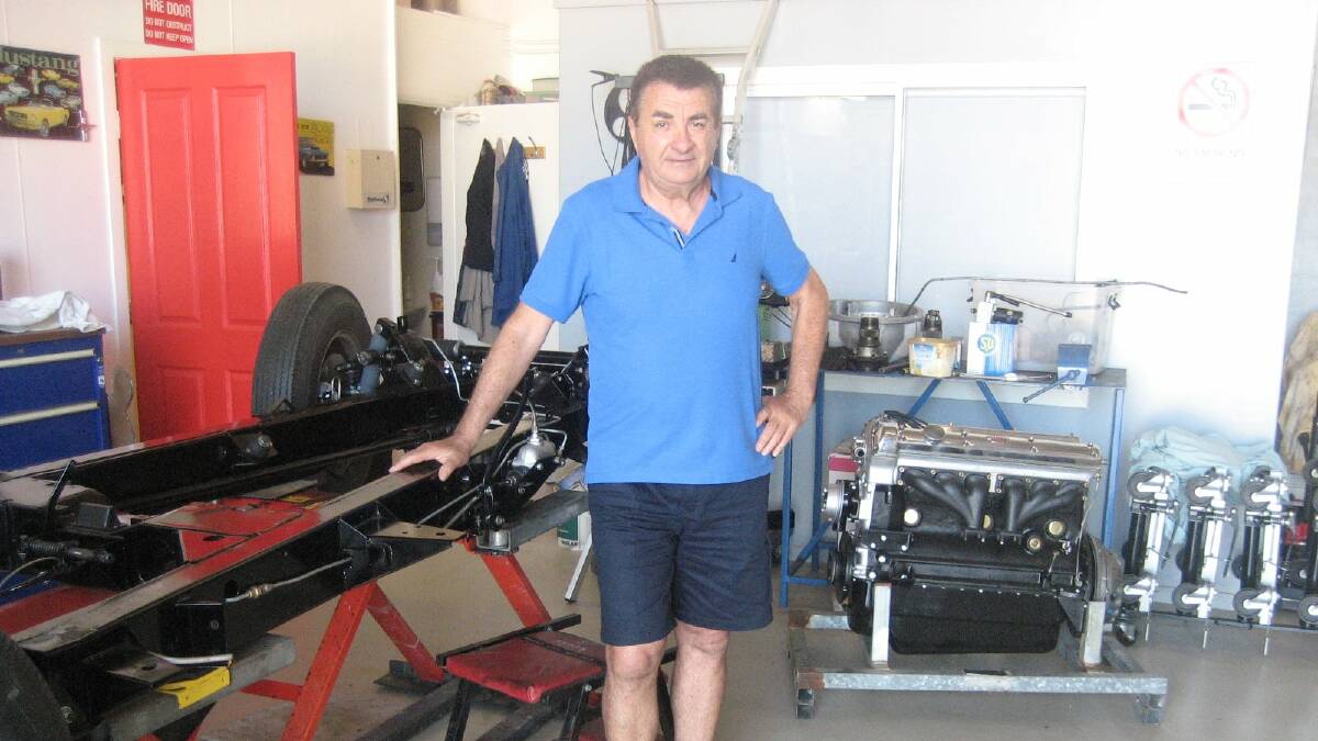 Wally Spychala with his XK140 chassis and engine in the background.