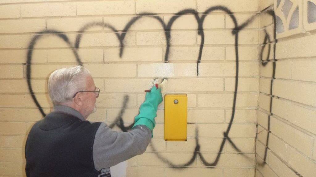Graffiti-buster Ted Bickford cleaning up the mess left by vandals at Hawks Nest.