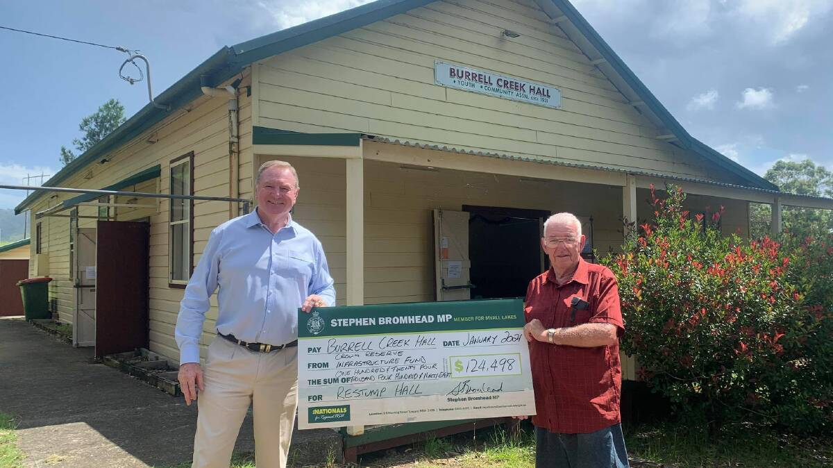 Stephen Bromhead presenting a cheque for $124,498 to a representative of Burrell Creek Hall.