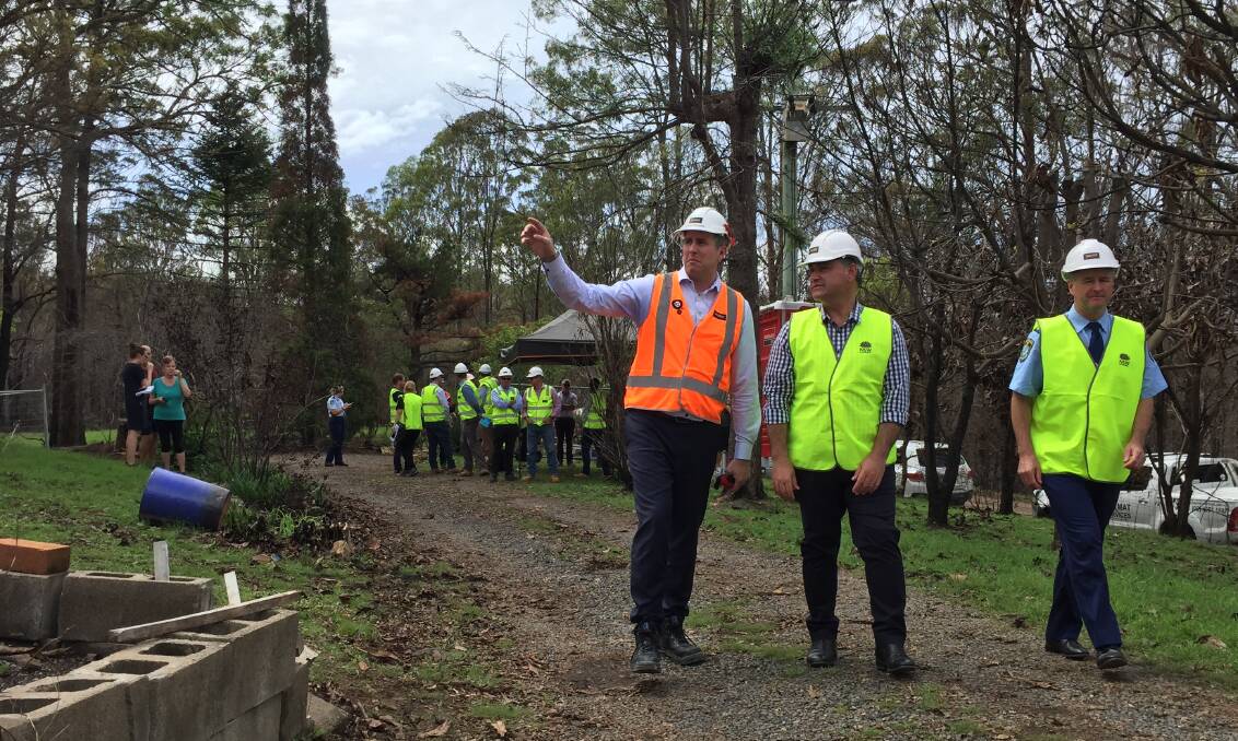 Cathal O'Rourke, John Barilaro and Mick Willing visit a razed home at Rainbow Flat as a part of the official launch of the State government's bushfire clean-up operation. 